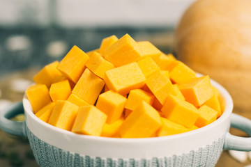 Sliced pumpkins in plate with seeds on kitchen table