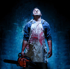 Bloody Halloween theme: crazy killer as butcher with electric saw