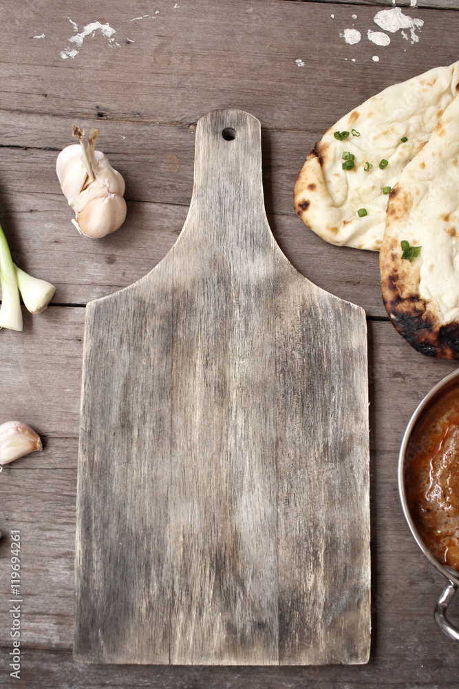 Wall mural indian naan bread with curry and chopping