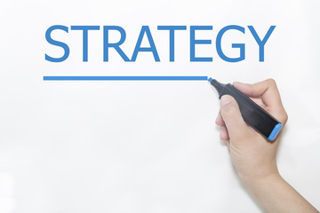Hand writing Strategy with marker on transparent wipe board.