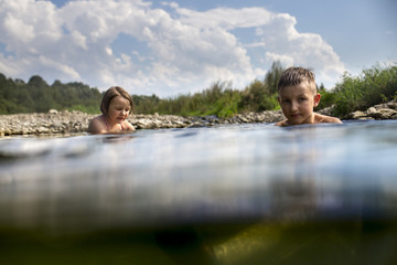 Kids swimming in the river during the holiday, summertime
