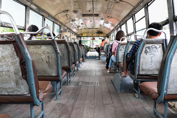 Fototapeta na wymiar People sitting inside a open air bus in Bangkok, Thailand