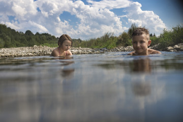 Kids swimming in the river during the holiday, summertime