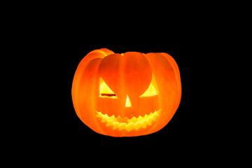 Ghost face on pumpkin and candle light for halloween background