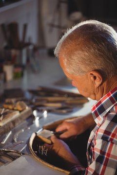 Goldsmith shaping metal with pilers