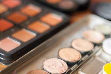 Blurry professional visagiste workspace. Makeup tools. Creative mess