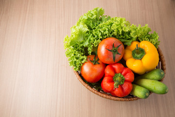 Tomato with fresh vegetable prepared in bowl on wooden t