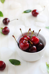 ripe cherries in a white bowl