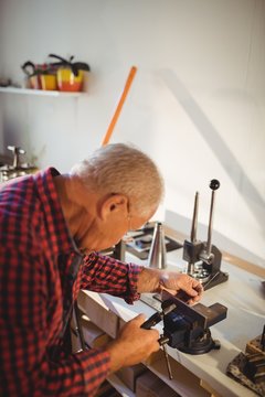 Goldsmith working in workshop