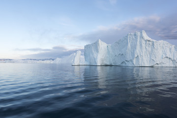 Fototapeta na wymiar Huge and beautiful icebergs on arctic ocean in Greenland