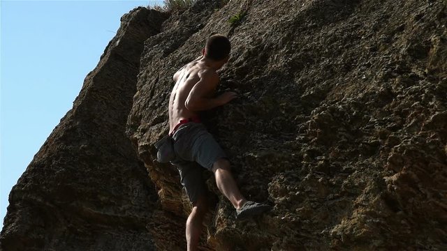 Young Extreme Climber Climbing On A Rock Without Insurance. Slow Motion Effect