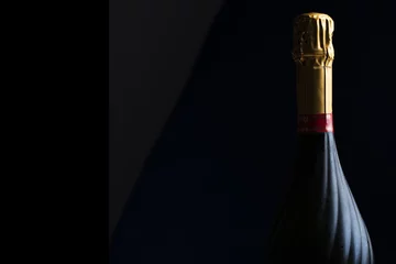 Photo sur Aluminium Bar Champagne bottle on a black background with space for text