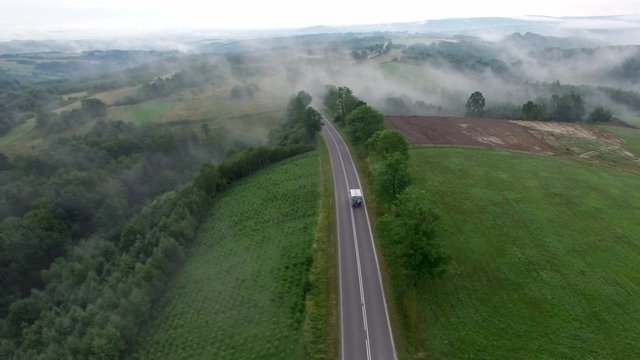 Aerial View Of Car On Foggy Rural Road