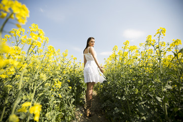 Fototapeta premium Young woman in the spring field