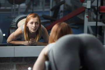 Young strong girl take breather in gym