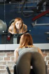 Young strong girl take breather in gym