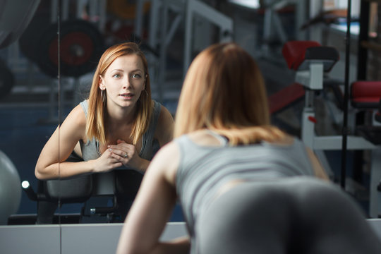 Young strong girl take breather in gym