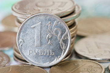 rubles coins against background of 1000 and 500 rubles banknotes
