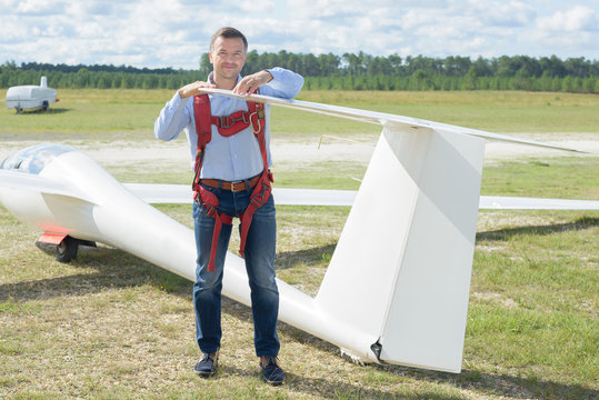 Man looking at tailpiece of glider