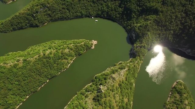 Aerial: camera tilt down pointing at heart of Uvac lake meandre, Serbia.
