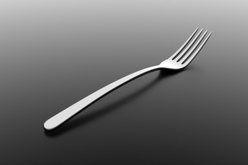 Silver fork on grey background