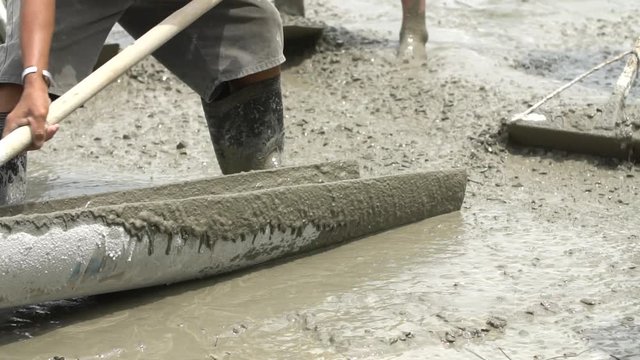 Non identify Construction workers pour concrete mix from cement mixer.Slow motion 120 fps.