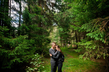 Naklejka na ściany i meble Young and beautiful couple alone in forest