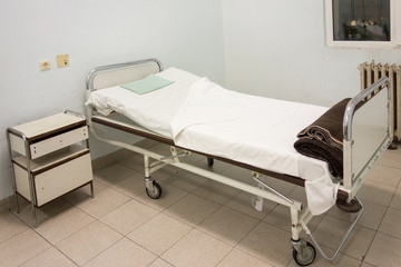 Interior of hospital room with old bed