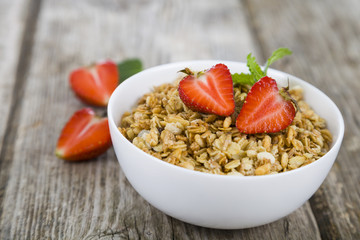 Granola with strawberry on a wooden table