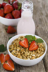 Granola with strawberry on a wooden table