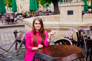 Young girl is sitting in empty cafe