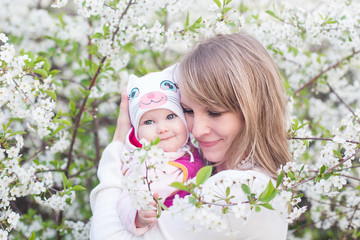 mother and child in nature against the backdrop of blooming gardens