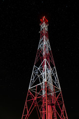 Radio towers at night with stars in the background