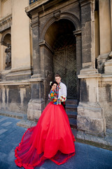 Fototapeta na wymiar Amazing wedding couple near old church's entrance