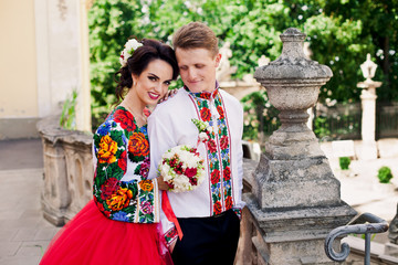 Smiling wedding couple is standing and posing together