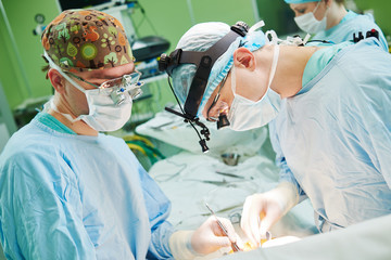 male cardiac surgeon at child cardiosurgery operating room