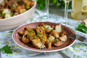 Baked fish with mushrooms, potatoes and onions with a glass of w