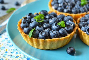 Tartlets with meringue and strawberries, festive table