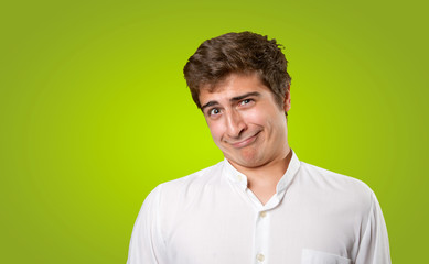 Close up of a naughty young man on green background