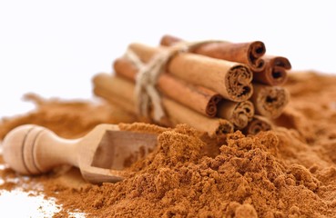 Cinnamon sticks and powder isolated background.
