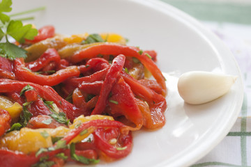 Dish of red and yellow peppers with garlic and parsley