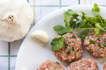 Dish of meatballs with garlic and parsley