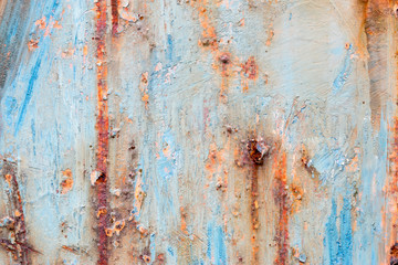 A background of peeling paint and rusty old metal