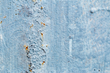 A background of peeling paint and rusty old metal