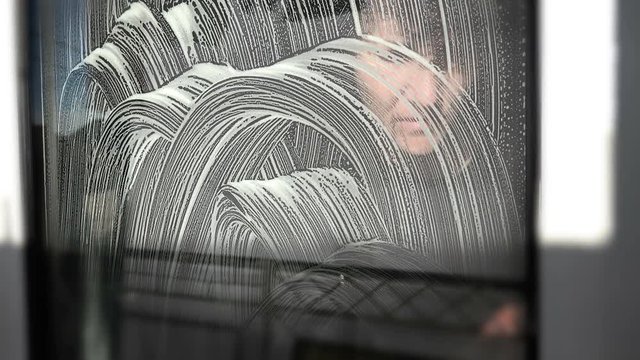 Girl wipes dusty glass cloth