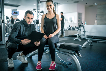 Personal trainer talks to his client.