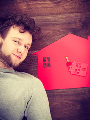 Man lying with house symbols.
