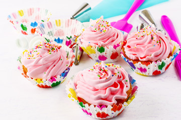 Homemade pink birthday cupcakes  and cookware