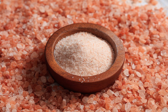 Wooden Bowl On Pink Salt Background