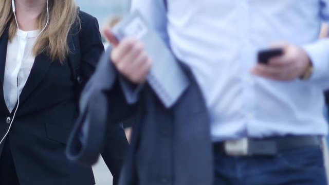 Businessman with paper notebook and phone walks in London City